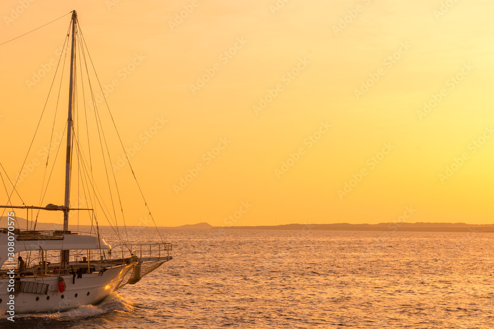 Fototapeta premium Sunset at sea. toned. Yacht in the sunset. copy space