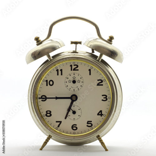 Old-style alarm clock, metal, it's quarter to seven.