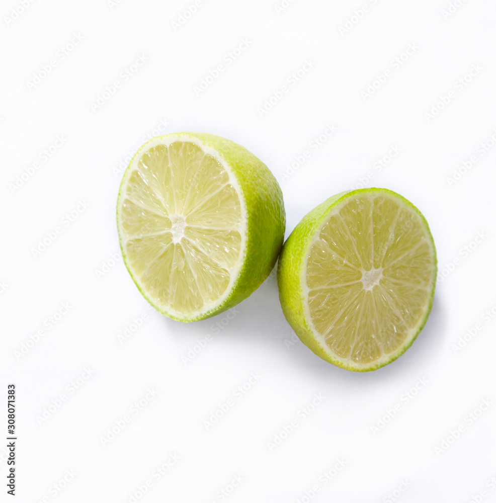 Natural fresh lime with water drops and slice of green lime citrus fruit stand isolated on white background.