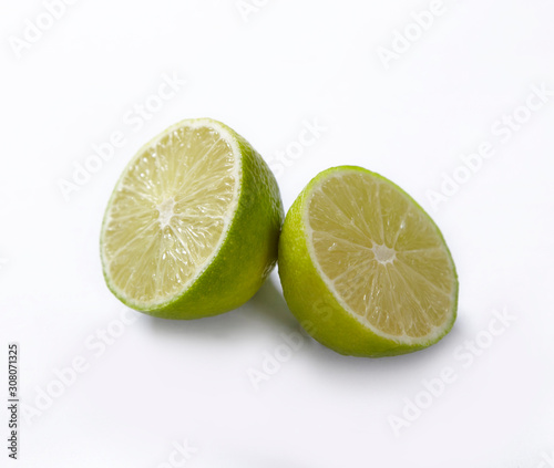 Natural fresh lime with water drops and slice of green lime citrus fruit stand isolated on white background.