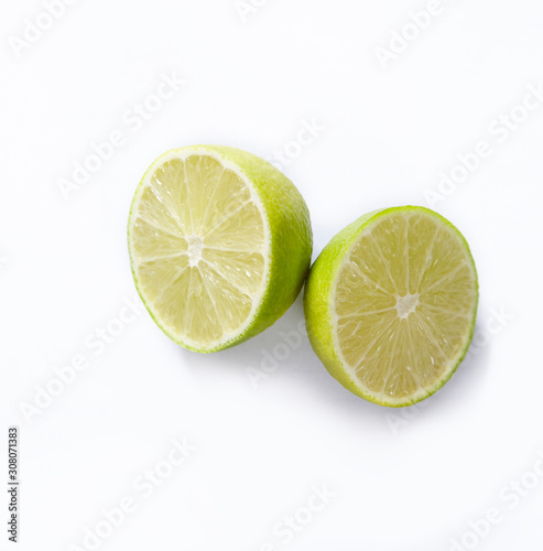 Natural fresh lime with water drops and slice of green lime citrus fruit stand isolated on white background.