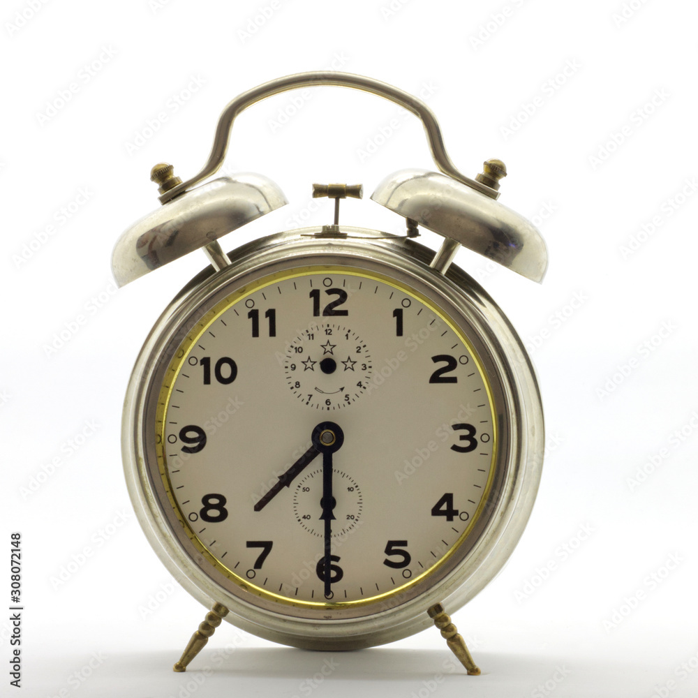 Old-style alarm clock, metal, it's half past seven. Old-style alarm clock, metal, it's half past seven.