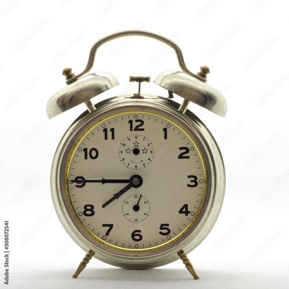 Old-style alarm clock, metal, it's quarter to eight. Old-style alarm clock, metal, it's quarter to eight.