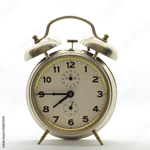 Old-style alarm clock, metal, it's quarter to eight.