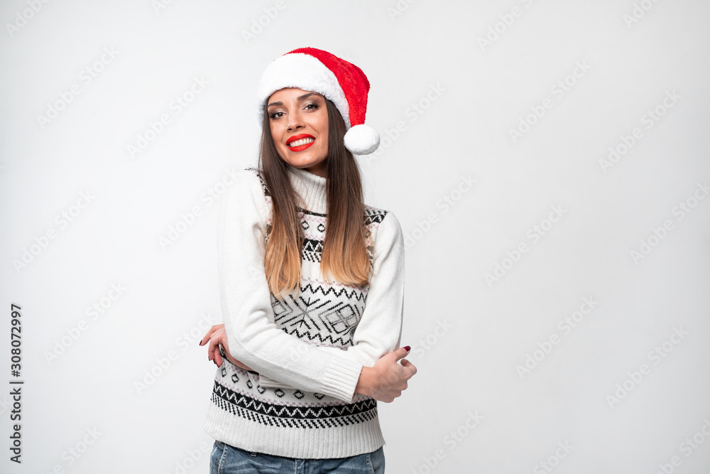 Close up portrait beautifiul caucasian woman in red Santa hat on white studio background. Christmas and New Year holiday concept. Close up portrait beautifiul caucasian woman in red Santa hat on white studio background. Christmas and New Year holiday concept.