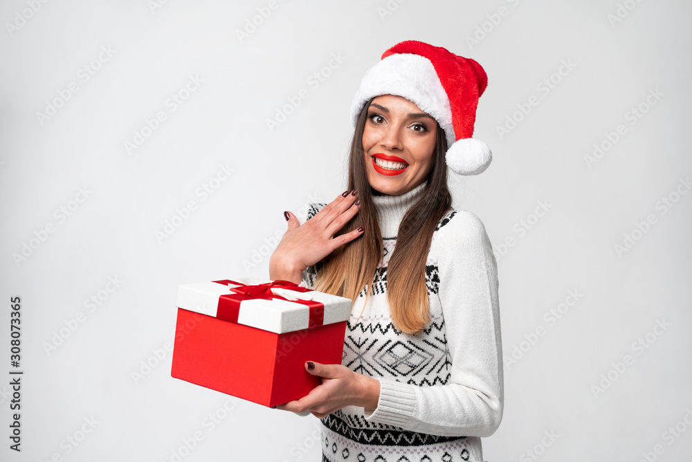 Close up portrait beautifiul caucasian woman in red Santa hat on white studio background. Christmas and New Year holiday concept. Close up portrait beautifiul caucasian woman in red Santa hat on white studio background. Christmas and New Year holiday concept.
