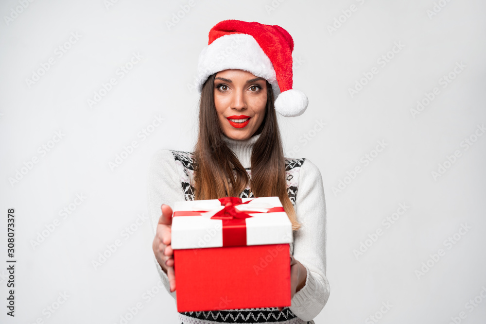 Close up portrait beautifiul caucasian woman in red Santa hat on white studio background. Christmas and New Year holiday concept. Close up portrait beautifiul caucasian woman in red Santa hat on white studio background. Christmas and New Year holiday concept.