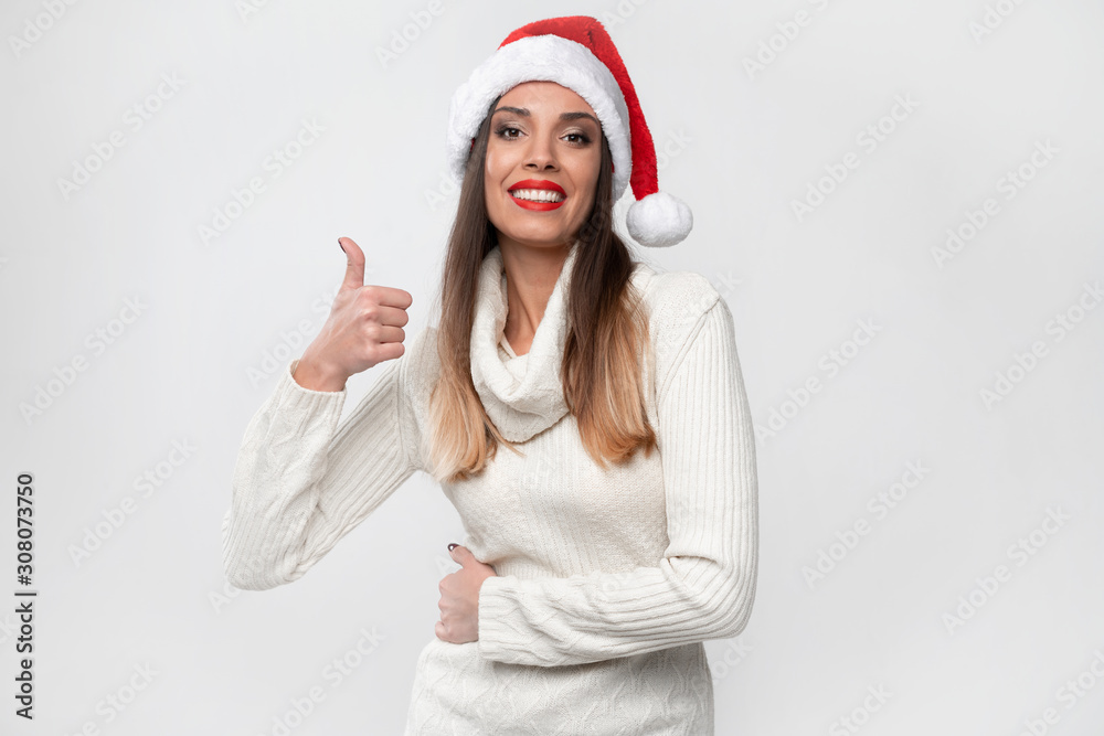 Close up portrait beautifiul caucasian woman in red Santa hat on white studio background. Christmas and New Year holiday concept. Close up portrait beautifiul caucasian woman in red Santa hat on white studio background. Christmas and New Year holiday concept.