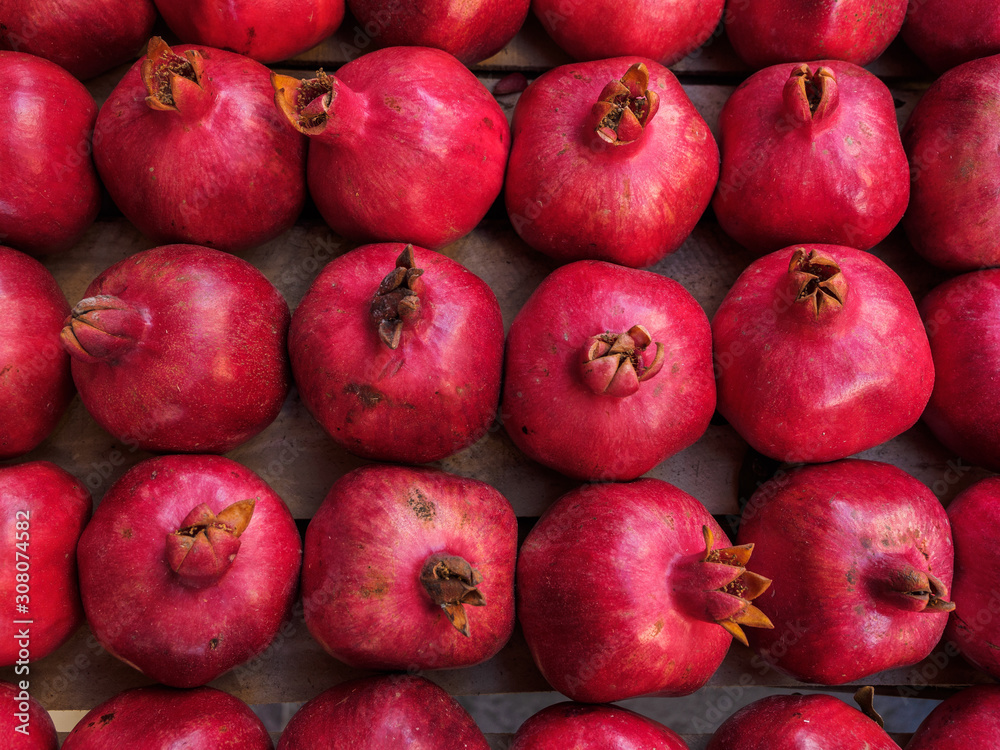 Red ripe pomegranate fruit lie in a box Red ripe pomegranate fruit lie in a box