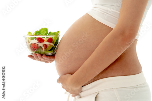 Pregnant Woman Holding Glass Bowl with Fresh Salad.