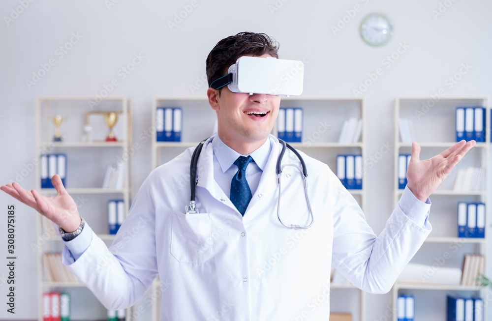 Young doctor with vr virtual reality headset working in the offi Young doctor with vr virtual reality headset working in the offi