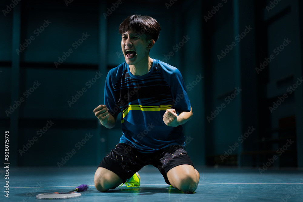 Asian badminton player is glad that he wins.competition Asian badminton player is glad that he wins.competition