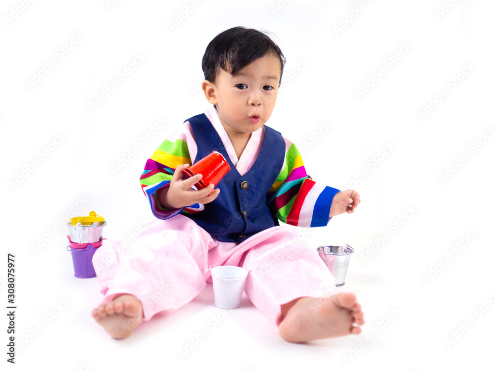 Asian little boy wearing a Korean Traditional Hanbok dress in white background Asian little boy wearing a Korean Traditional Hanbok dress in white background