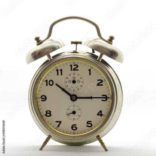 Old-style alarm clock, metal, it's quarter past ten.