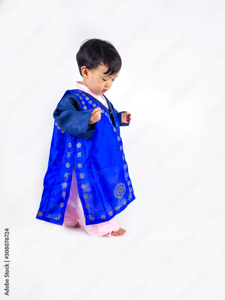 Asian little boy wearing a Korean Traditional Hanbok dress in white background Asian little boy wearing a Korean Traditional Hanbok dress in white background