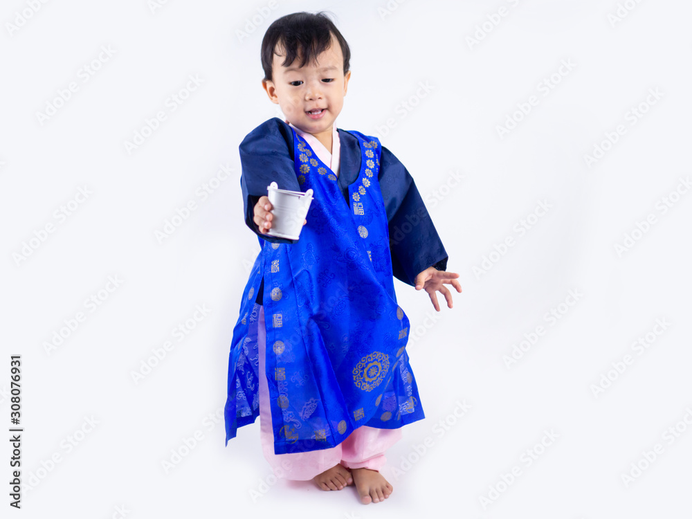 Asian little boy wearing a Korean Traditional Hanbok dress in white background Asian little boy wearing a Korean Traditional Hanbok dress in white background