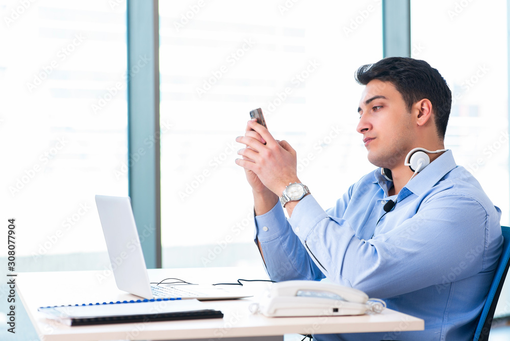 Male call-center operator in business concept Male call-center operator in business concept