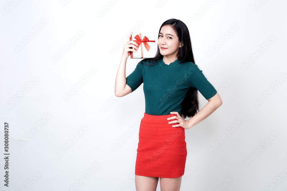 Woman holding gift box and toothy smiling Woman holding gift box and toothy smiling