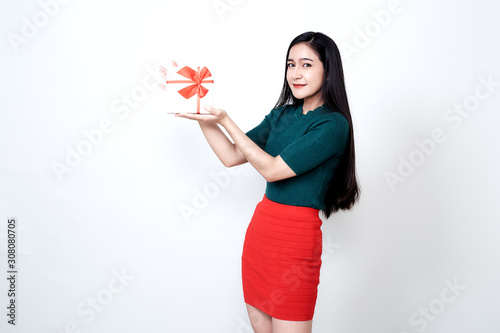 Woman holding gift box and toothy smiling