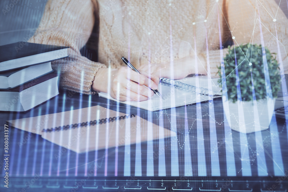 Forex graph on hand taking notes background. Concept of research. Double exposure Forex graph on hand taking notes background. Concept of research. Double exposure
