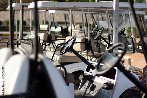 Golf cars in the parking lot.