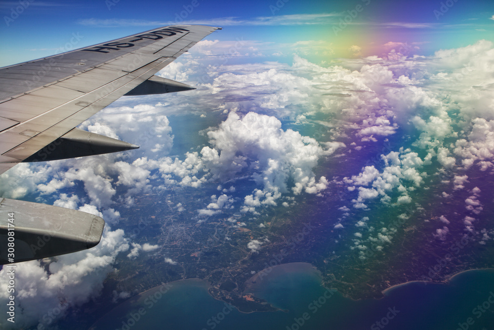 Airplane wing, clouds and sky during the flight. Shot with a polarizing filter for the lens.