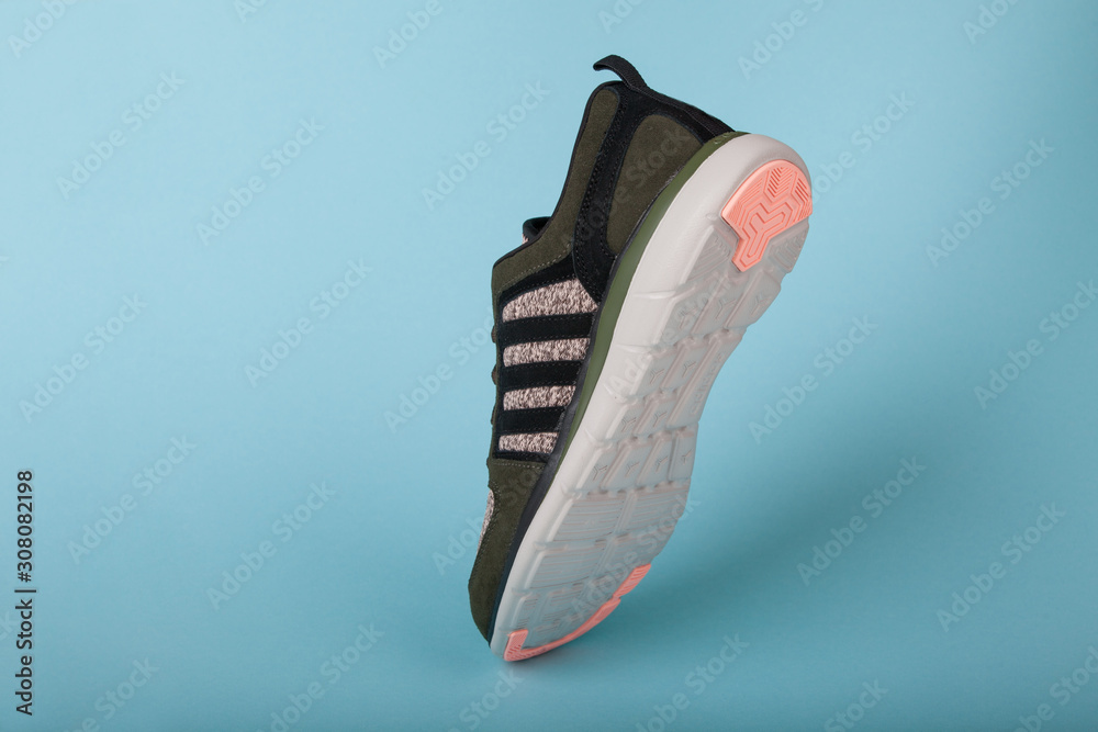 Varna , Bulgaria - APRIL 13, 2019 : ADIDAS X Woman sport shoe, on blue background. Product shot. Adidas is a German corporation that designs manufactures sports shoes foto de Stock | Adobe Stock