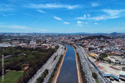 Aerial view of river between roads. Cityscape scenery. Great landscape. Marginal Tietê, São Paulo, Brazil