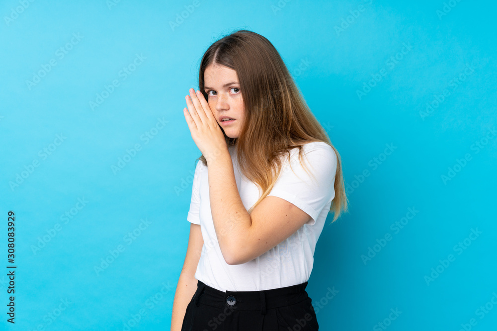 Ukrainian teenager girl over isolated blue background whispering something Ukrainian teenager girl over isolated blue background whispering something