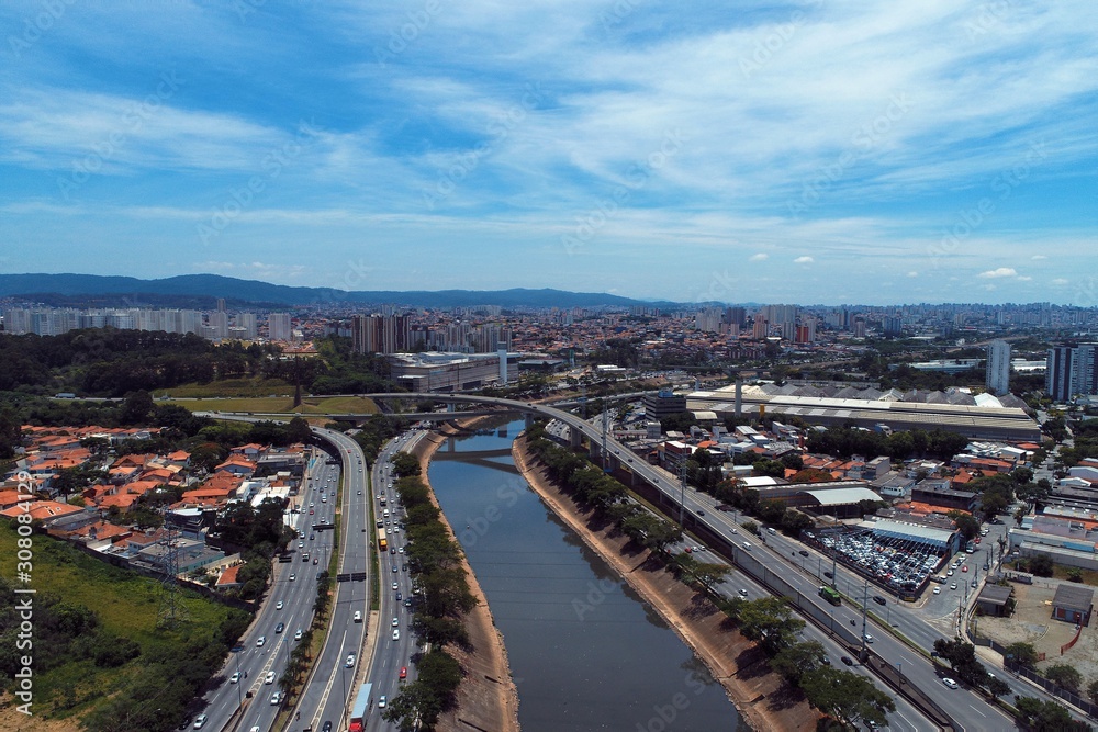 Aerial view of river between roads. Cityscape scenery. Great landscape. Marginal Tietê, São Paulo, Brazil