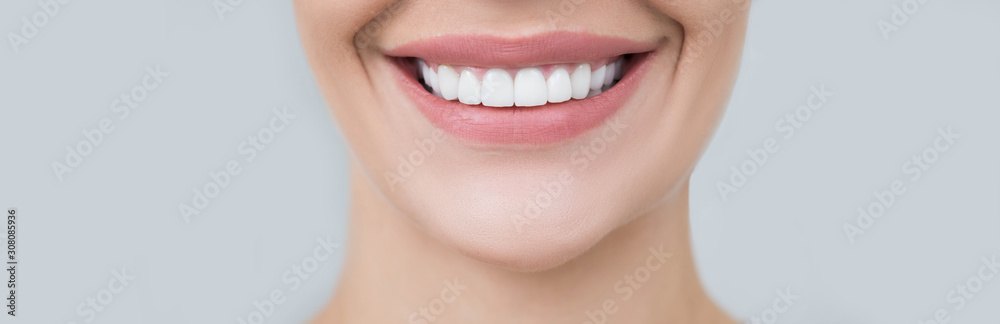 Perfect female smile on gray background. Healthy white teeth, advertising dentistry - obrazy, fototapety, plakaty 