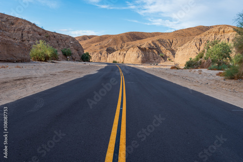Landscape of a road leading through a barren stone canyon at the Mecca Wilderness in Southern California