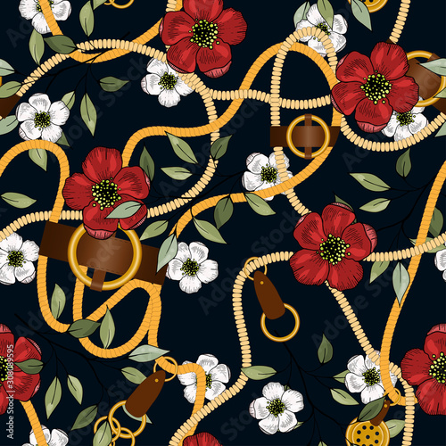 Vintage gold jewelry of necklace and rustic ropes, tassels and belts with leaves and red white flowers.