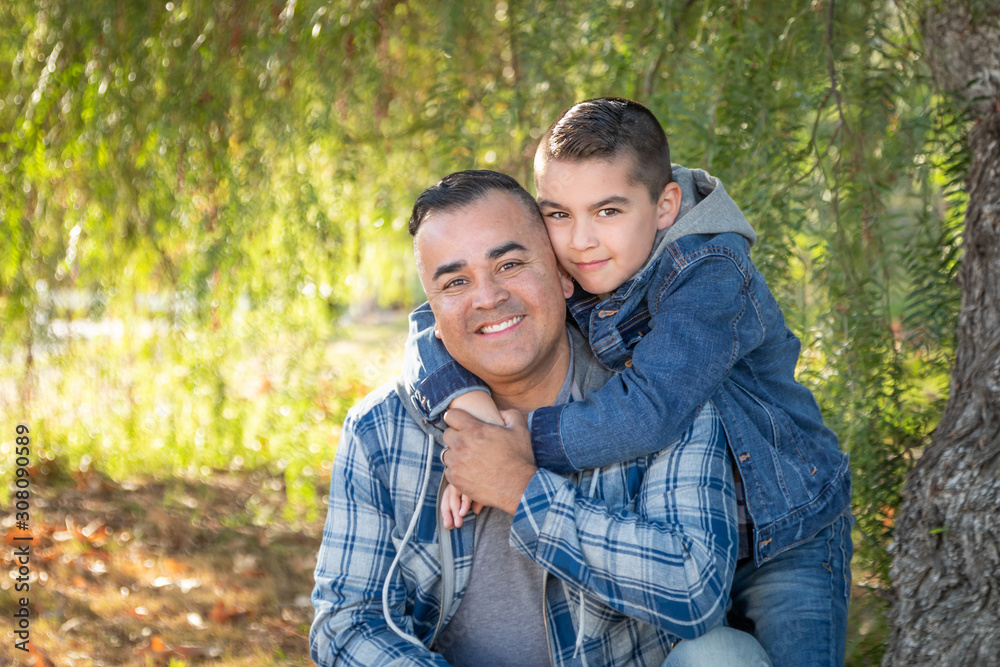 Fototapeta premium Portrait of Mixed Race Father And Son Having Fun Outdoors