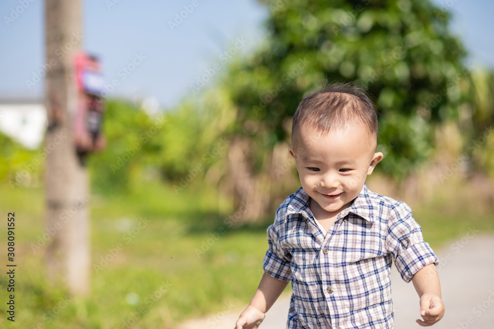Portrait of little adorable child playing outdoor, Close up shot of happy kid running Portrait of little adorable child playing outdoor, Close up shot of happy kid running