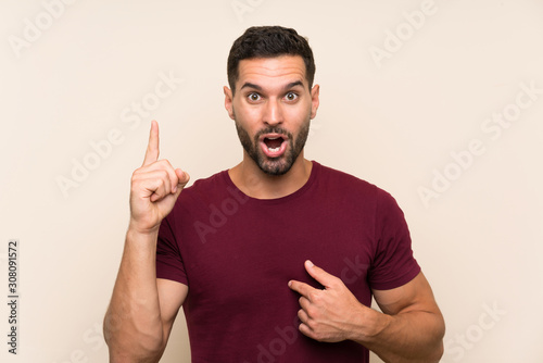 Handsome man over isolated background with surprise facial expression