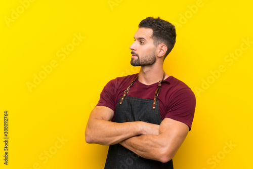 Barber man in an apron looking to the side