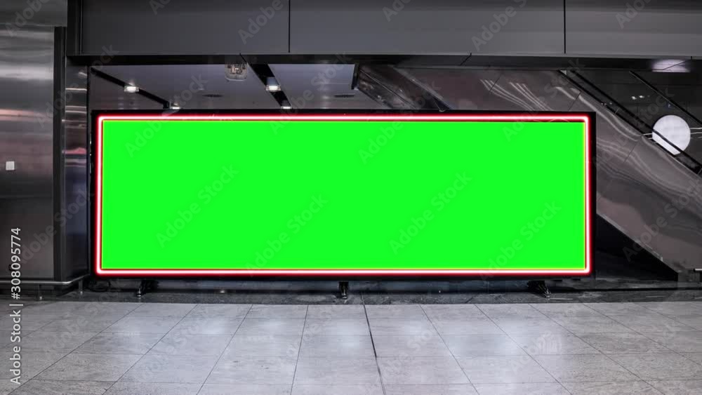 Empty blank widescreen billboard with green screen, alpha channel. Chroma key frame on airport hall, big banner for marketing. Empty blank widescreen billboard with green screen, alpha channel. Chroma key frame on airport hall, big banner for marketing.