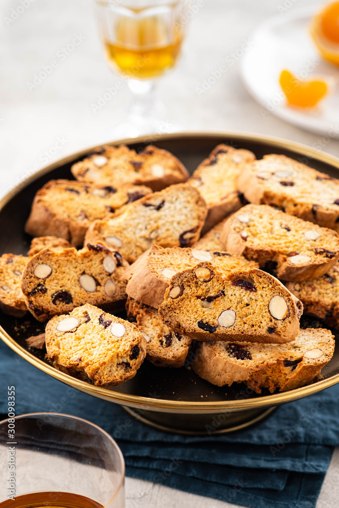 Italian almond biscotti biscuits and sweet wine in a glass on the table. Copy space.