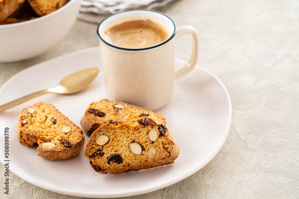 Italian biscotti cookies with a cup of coffee on a light background. Italian biscotti cookies with a cup of coffee on a light background.