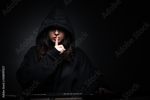 Female hacker hacking security firewall late in office photo