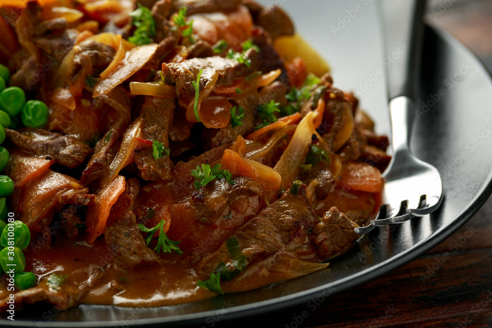 Classic beef stroganoff servei with boiled baby potato and sweet peas