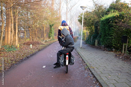 Checking your phone on the back of a bike in Amsterdam