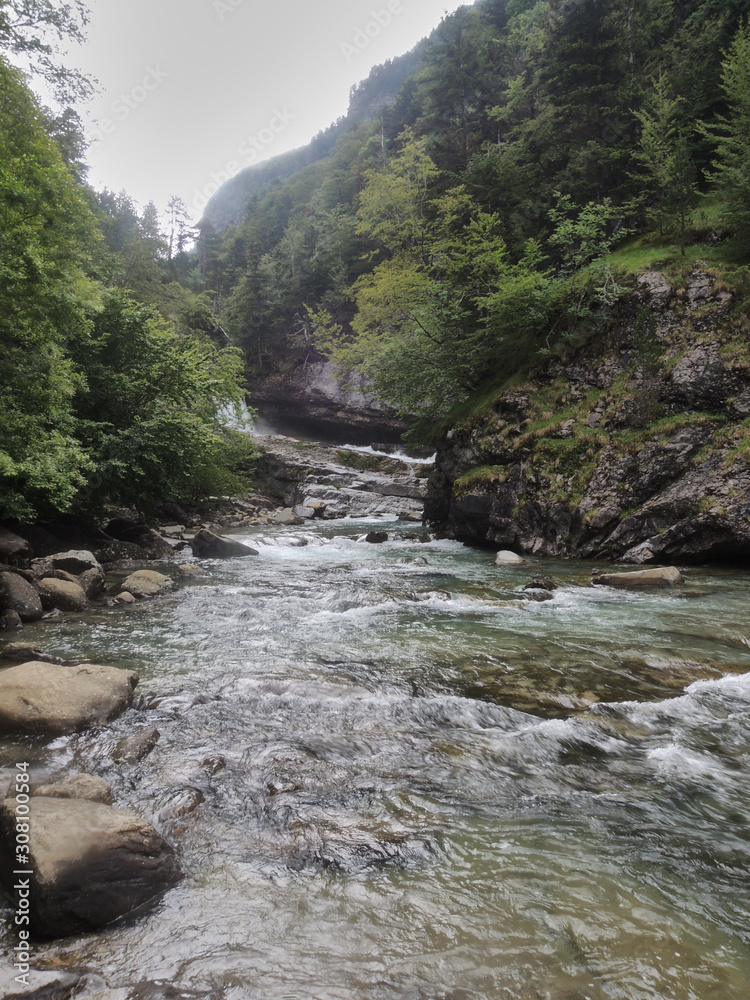 The Arazas river in the Ordesa valley. National Park of Ordesa and Monte Perdido in the Pyrenees of the province of Huesca. Aragon. Spain The Arazas river in the Ordesa valley. National Park of Ordesa and Monte Perdido in the Pyrenees of the province of Huesca. Aragon. Spain