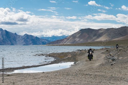 Ladakh, India - Aug 05 2019 -  Riders at Pangong Lake view from Between Spangmik and Maan in Ladakh, Jammu and Kashmir, India. photo