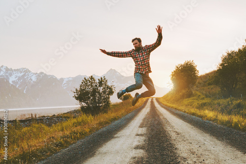 Slika na platnu Man jumping over mountain road outdoor travel lifestyle adventure vacations acti