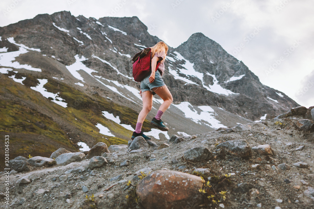 Woman exploring mountains with backpack hike adventure vacation healthy lifestyle outdoor summer activity solo climbing in Norway