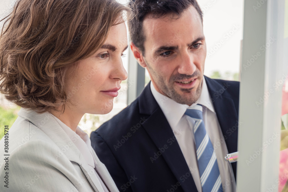 Business men and business women take notes and chat Business men and business women take notes and chat