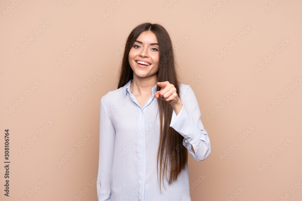 Young woman over isolated background surprised and pointing front Young woman over isolated background surprised and pointing front