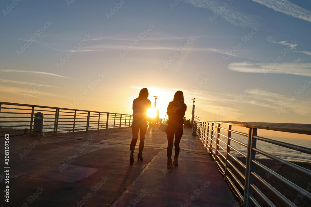Girls walking into the sunset on Hermosa Pier.